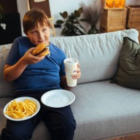 boy eating junk food at home - junk food stock pictures, royalty-free photos & images