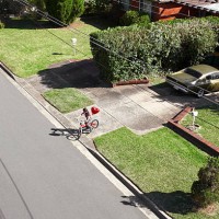 boy on bike with red heart shaped balloon - garden decoration stock pictures, royalty-free photos & images