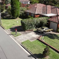 boy with red balloon in front of house - garden decoration stock pictures, royalty-free photos & images