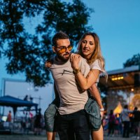 boyfriend giving his girlfriend a piggyback ride at the music festival - concert stock pictures, royalty-free photos & images