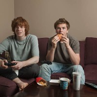 boys playing video games - junk food stock pictures, royalty-free photos & images