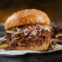 braised beef short rib sandwich with coleslaw on a brioche bun - junk food stock pictures, royalty-free photos & images