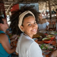 brazilian woman eating with friends at a beach restaurant - food stock pictures, royalty-free photos & images
