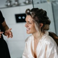 bride getting ready for wedding with stylist using hairspray and curlers - hairstyle stock pictures, royalty-free photos & images