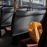 Brown paper bag from Monopoly is still on a seat of a London bus after its user has left, on 15th April 2019, in London, England.