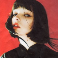 brunette asian woman in studio on red background. fashion model. scanned film photo. dust and scratches on photo. - fashion stock pictures, royalty-free photos & images