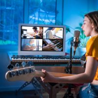 brunette teen musician singer girl singing and playing bass guitar teleconference - concert stock pictures, royalty-free photos & images