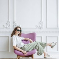 brunette woman model in sunglasses posing in studio sitting on armchair catalog - home decoration stock pictures, royalty-free photos & images