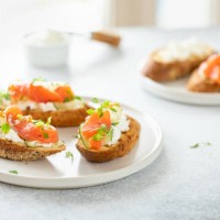 bruschetta with salmon, curd cheese and cucumber on toast in high key style on white background. - food stock pictures, royalty-free photos & images