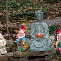 buddha figure and garden gnomes - garden decoration stock pictures, royalty-free photos & images
