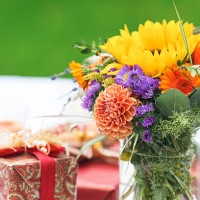 bunch of flowers and gift on outdoor table - garden decoration stock pictures, royalty-free photos & images