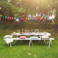 buntings hanging over food served on decorated picnic table at back yard - garden decoration stock pictures, royalty-free photos & images