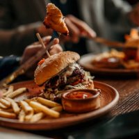 burger and french fries served on a table in the restaurant - junk food stock pictures, royalty-free photos & images