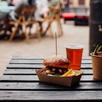 burger on a wooden table outdoor - junk food stock pictures, royalty-free photos & images