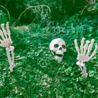 buried skeleton in yard - garden decoration stock pictures, royalty-free photos & images