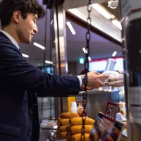 business break at lunch, korean business man eating on the go - junk food stock pictures, royalty-free photos & images