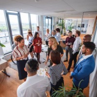 business colleagues enjoying sparkling wine and conversation - food stock pictures, royalty-free photos & images