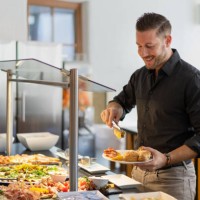 business man at hotel restaurant buffet - food stock pictures, royalty-free photos & images