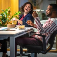 business people laughing on table - food stockfoto's en -beelden