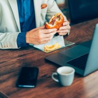 businessman eating fast food in the office - junk food stock pictures, royalty-free photos & images