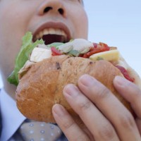 businessman eating sandwich - junk food stock pictures, royalty-free photos & images
