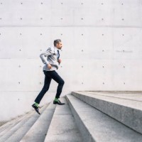 businessman running up stairs outdoors - fashion stock pictures, royalty-free photos & images