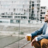 businessman sitting on bridge having coffee break - junk food stock pictures, royalty-free photos & images