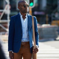 businessman walking on pedestrian crossing with shoulder bag - fashion stock pictures, royalty-free photos & images