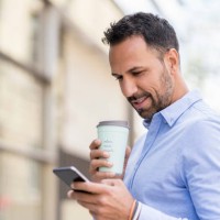 businessman with with takeaway coffee and cell phone in the city - junk food stock pictures, royalty-free photos & images