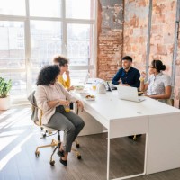 businesspeople eating lunch together in office - junk food stock pictures, royalty-free photos & images