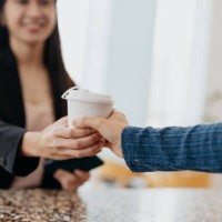 businesswoman buying take out coffee at a cafe - junk food stock pictures, royalty-free photos & images