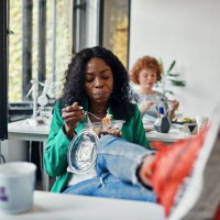 businesswoman having lunch break in office with feet on desk - junk food stock pictures, royalty-free photos & images