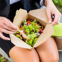 businesswoman having lunch outdoors, partial view - junk food stock pictures, royalty-free photos & images