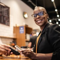 businesswoman paying with qr with mobile in a coffeeshop - junk food stock pictures, royalty-free photos & images