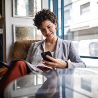 businesswoman using mobile phone while waiting at cafe - fashion stock pictures, royalty-free photos & images