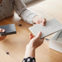 businesswomen holding samples over table in office - home decoration stock pictures, royalty-free photos & images