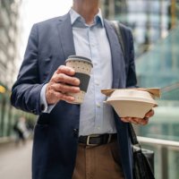 busy business professional enjoying takeout coffee and lunch while navigating the streets of sydney during a workday - junk food stock pictures, royalty-free photos & images