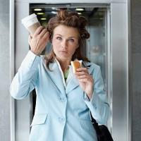 busy businesswoman eating on the go - junk food stock pictures, royalty-free photos & images