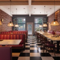 cafe interior with red seats, marble tables, pendant lights and brick walls - junk food stock pictures, royalty-free photos & images