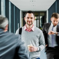 calm businessman in contrast to businessmen in a hustle - junk food stock pictures, royalty-free photos & images