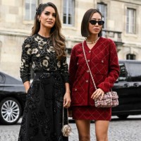 Camila Coelho and Aimee Song are seen wearing Chanel black and red outfits with Chanel bags outside the Chanel show during the Womenswear...