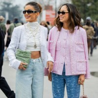 Camila Coelho wears white cropped turtleneck, jacket, denim jeans, green bag, necklace, sunglasses & Aimee Song wears pink button up blouse, jacket,...