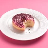 can't resist temptation bite out of doughnut - junk food stock pictures, royalty-free photos & images
