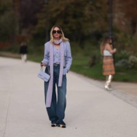 Candela Pelizza is seen wearing a lilac color long scarf, a purple cardigan, baggy blue jeans, Chanel black lace ballerinas, a purple Chanel Classic...