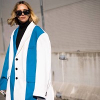 Candela Pelizza poses ahead of the Marni fashion show wearing black t-shirt and an oversized jacket blue and white during the Milan Fashion Week...