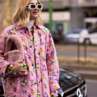Candela Pelizza poses ahead of the MSGM fashion show wearing a pink floral printed sequins shirt, pink floral printed pants and jacket, pink fur bag...