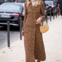 Candela Pelizza wears a yellow Chanel tweed coat, beige Chanel bag and yellow Chanel heels, outside Chanel, during the Womenswear Spring/Summer 2024...
