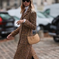 Candela Pelizzais seen outside Chanel show wearing black Chanel sunnies, white shirt underneath, beige and black checkered Chanel coat, black and...
