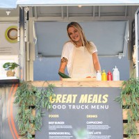 candid portrait of young woman working at food truck - junk food stock pictures, royalty-free photos & images