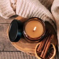 candle in small amber glass jar with wooden wick on wooden stand on background. top view - home decoration stock pictures, royalty-free photos & images